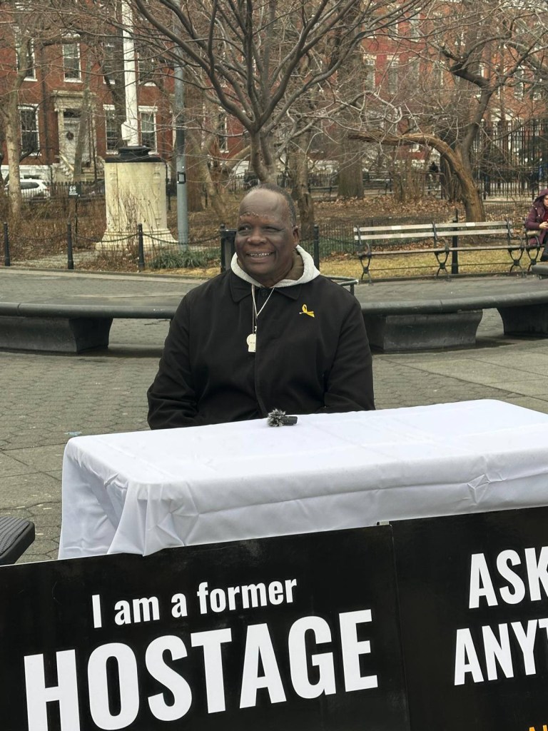 Simon Deng, a former child slave from South Sudan, engaging with passersby in Washington Square Park to discuss his past experiences