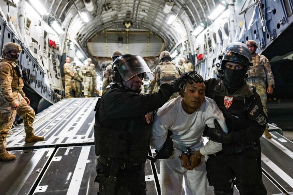 Police escort an alleged member of the Venezuelan gang Tren de Aragua and MS-13 who was deported by the U.S. government to be imprisoned in the Terrorism Confinement Center (CECOT) prison, at the El Salvador International Airport in San Luis Talpa, El Salvador April 12, 2025.