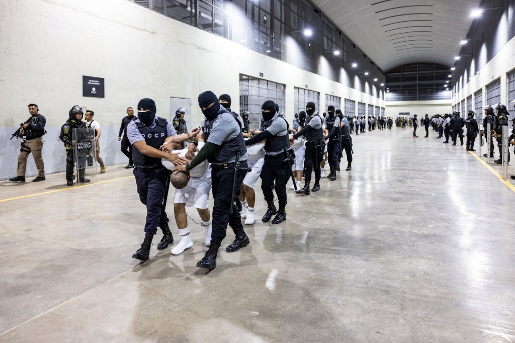 Salvadoran prison guards escorting deported members of Venezuelan gang Tren de Aragua and MS-13 gang to the CECOT prison in Tecoluca, El Salvador