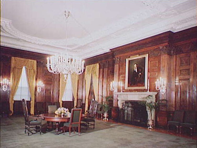 The White House State Dining Room, circa 1948, with wood paneling and carpet