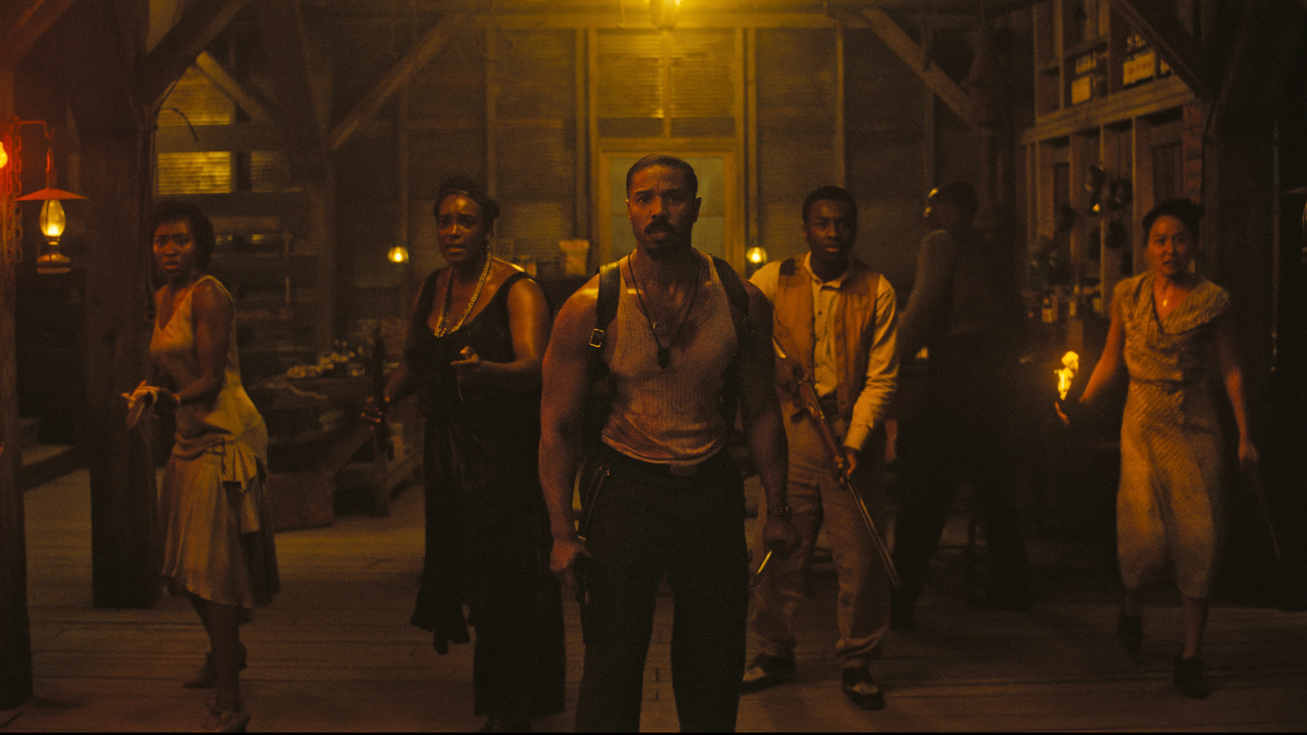 A still from Sinners, showing a group of people armed with weapons