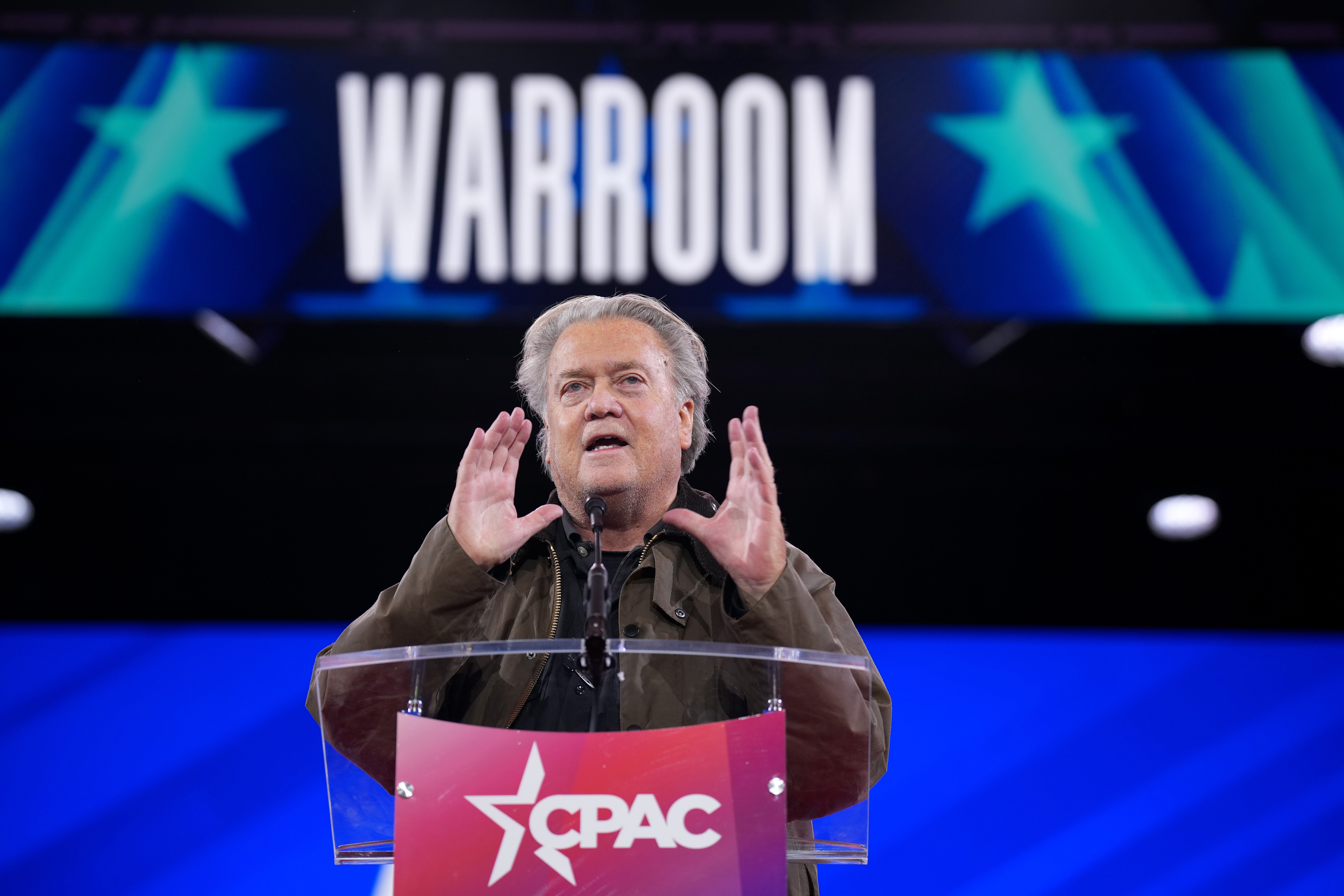 Steve Bannon motioning with his hands at a CPAC lectern.
