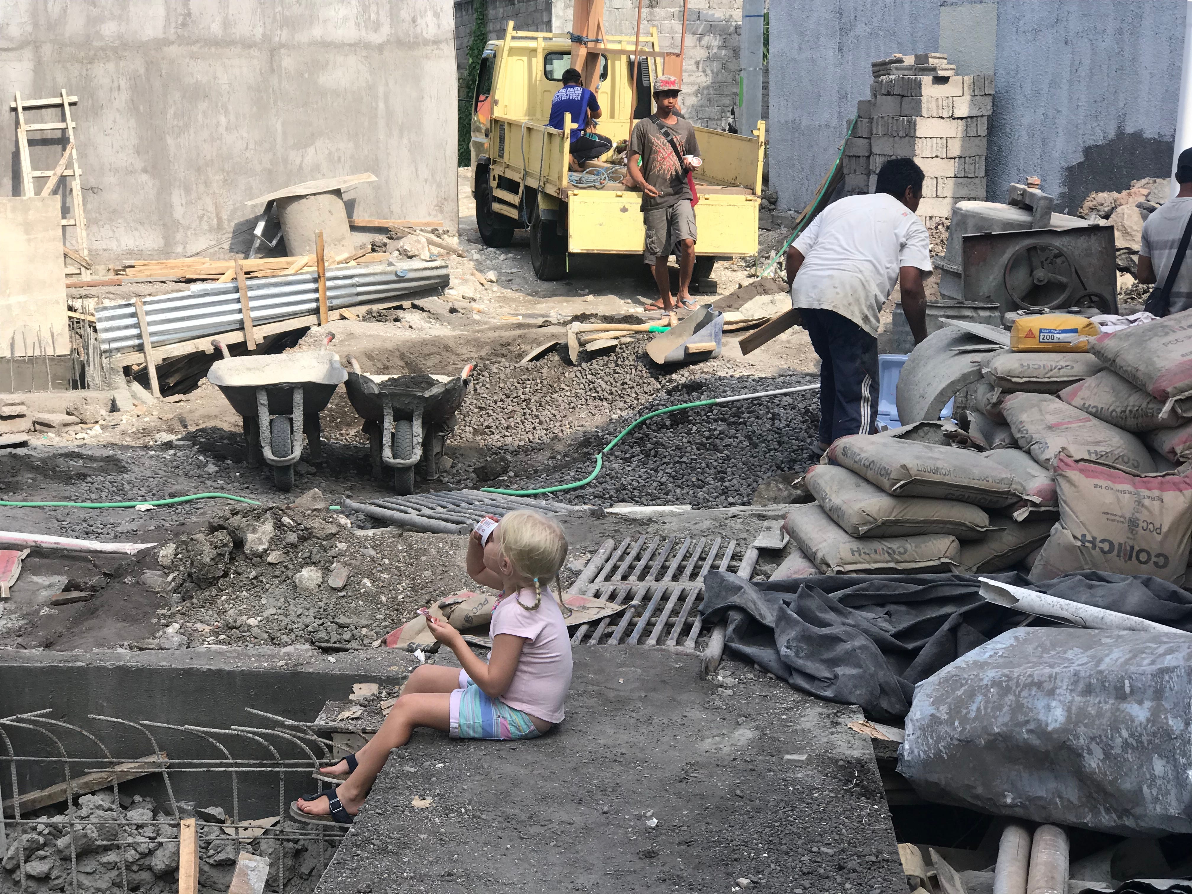 One of the family's daughters on site while the villas were being constructed.