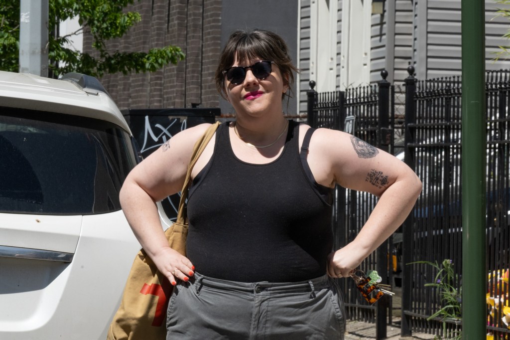 Emily Gallagher stands next to her car.