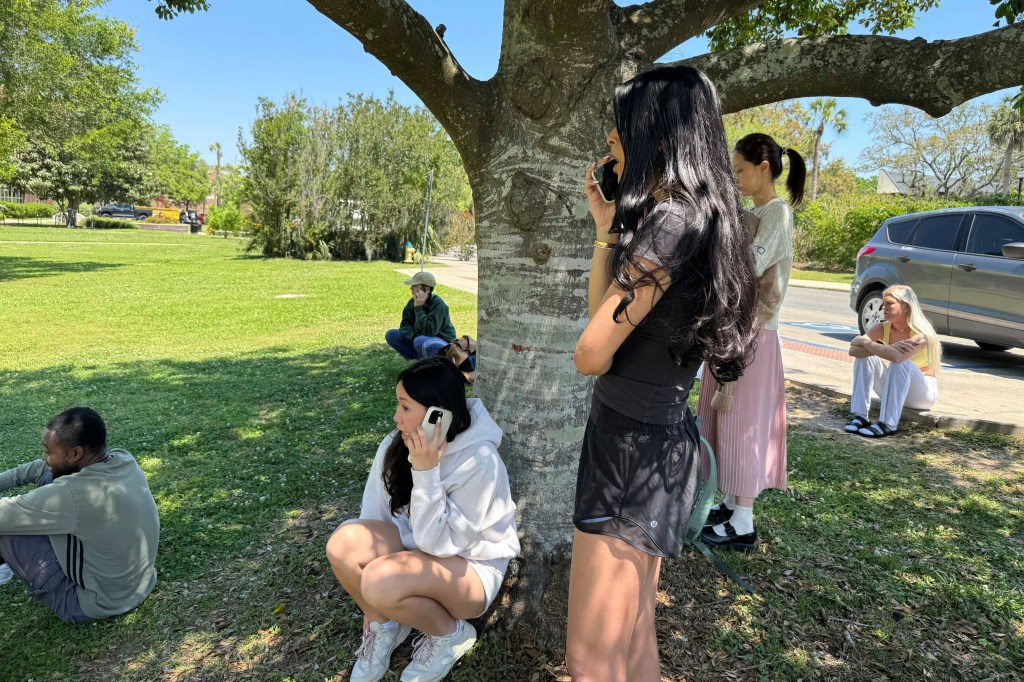 Florida State University students wait for news amid an active shooter incident at the schools campus in Tallahassee, Fla., Thursday, April 17, 2025