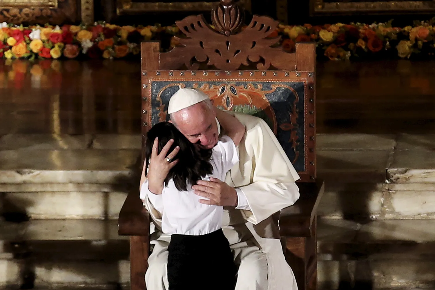 Pope Francis hugs a child