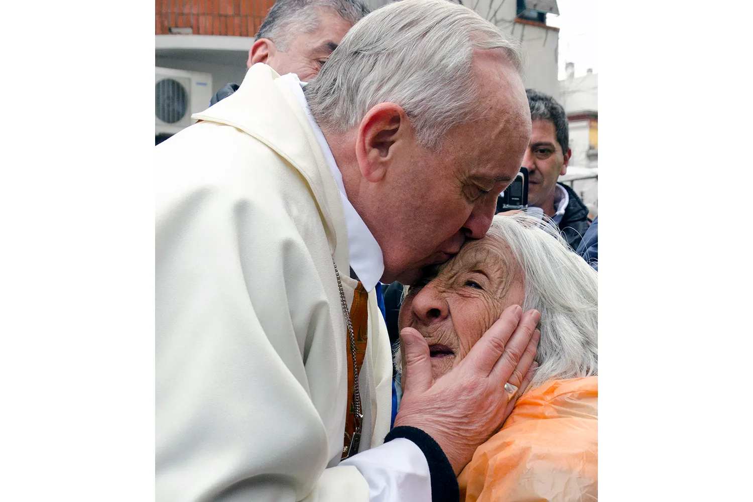 Cardinal Bergoglio hugs a woman