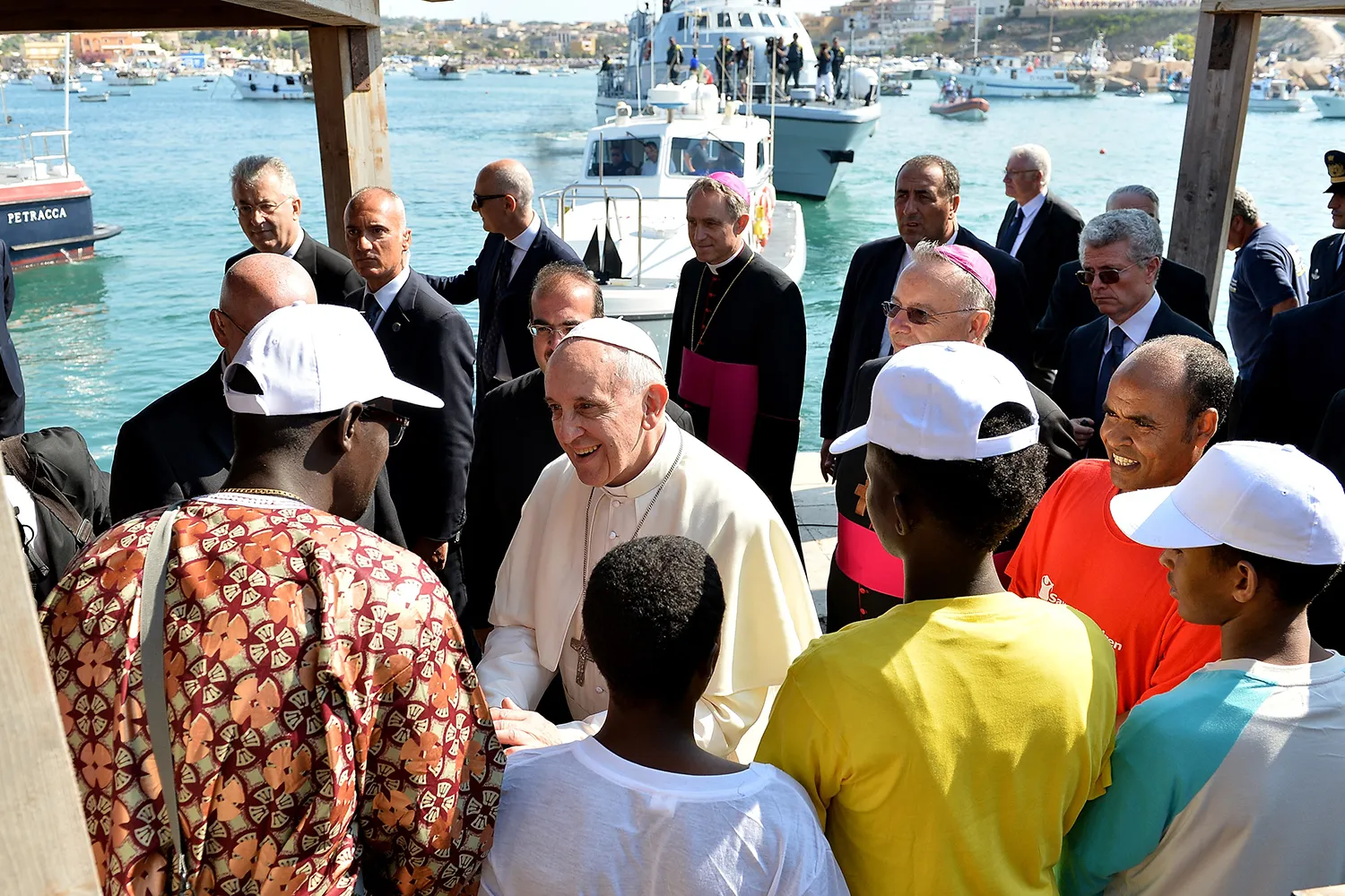 Pope Francis meets with immigrants at a pier
