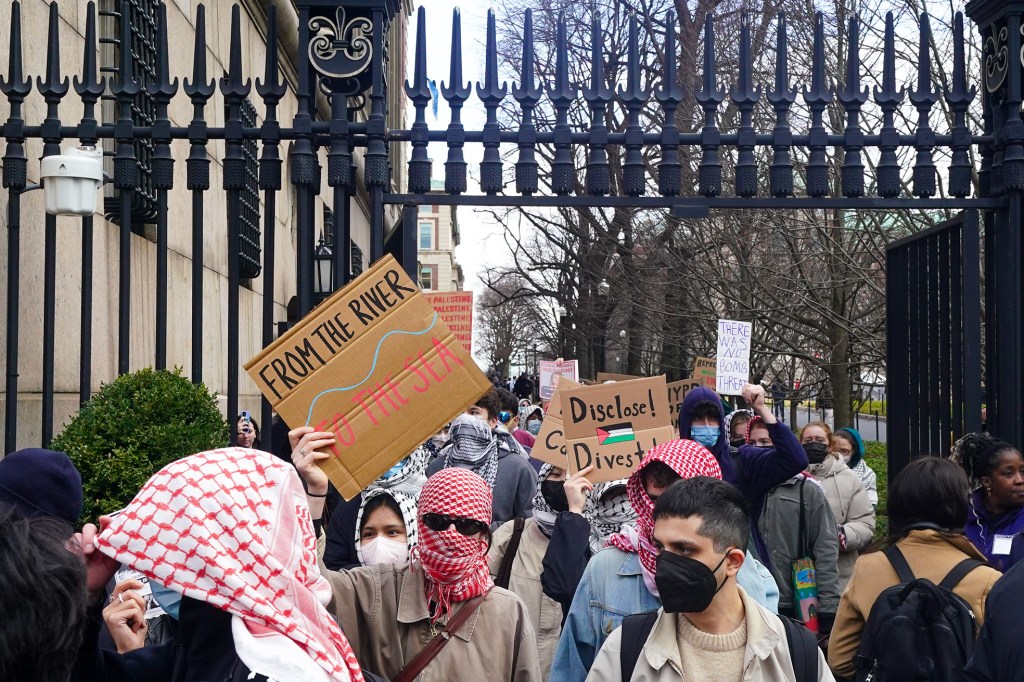 Columbia University students seen marching off school grounds, some with faces covered, and walked across street to Barnard College