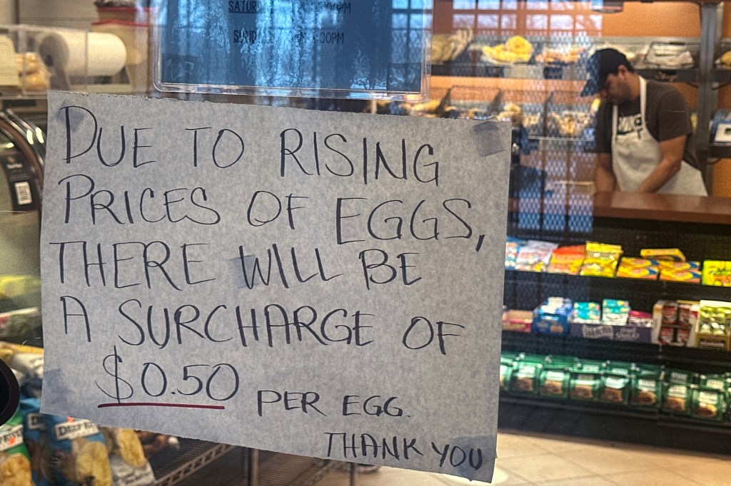 A sign indicating a price increase in eggs hanging in a bagel store in Queens, New York City, on February 27, 2025.