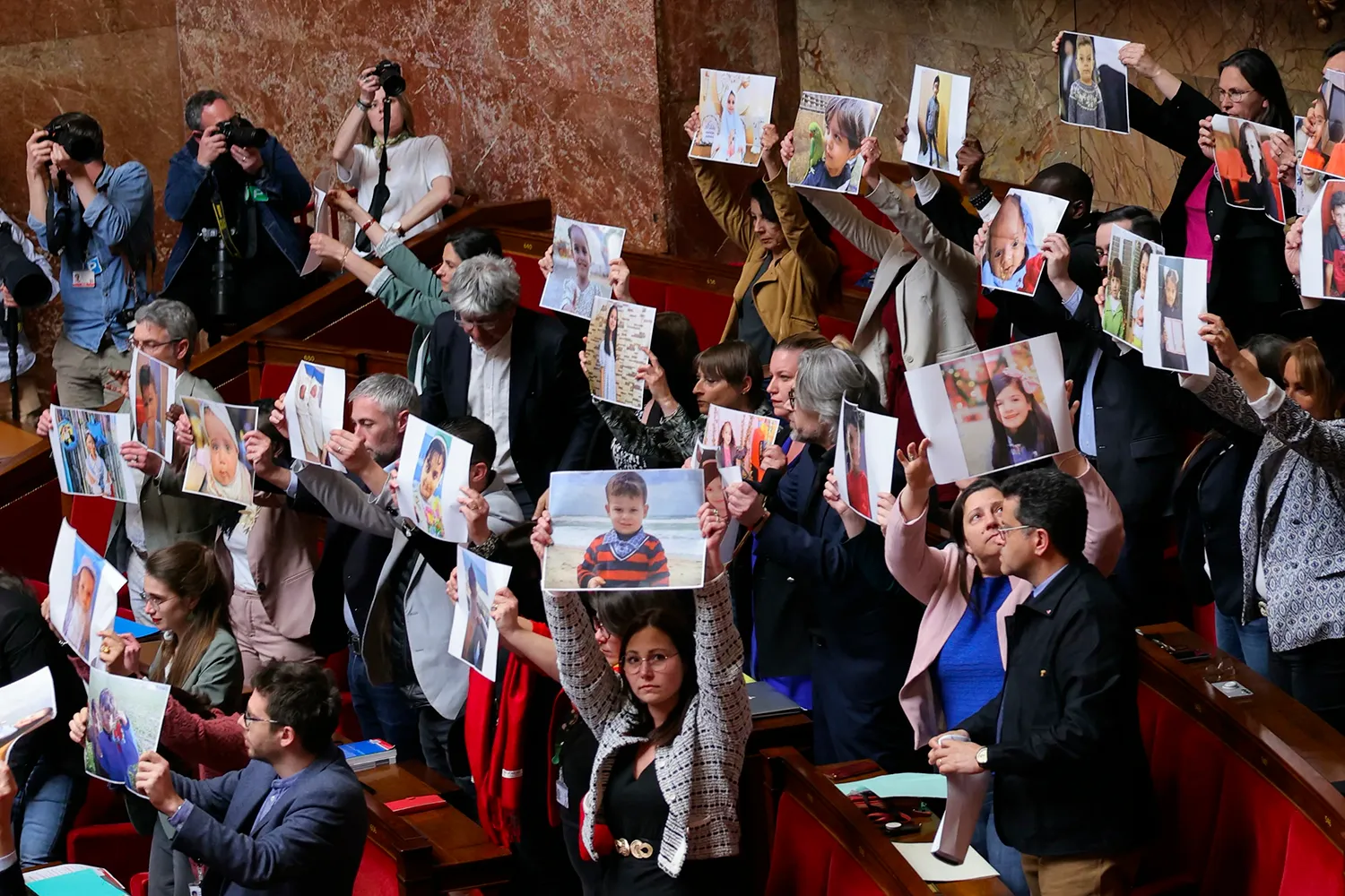 Left wing MPs hold portraits of children they claim have been killed amid Israel's military offensive in Gaza.