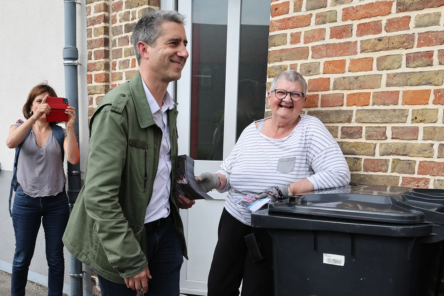 François Ruffin speaks with local residents as he goes door to door during a campaign