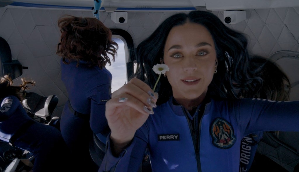 A photo of Katy Perry holding a daisy during thr 11-minute Blue Origin space flight.