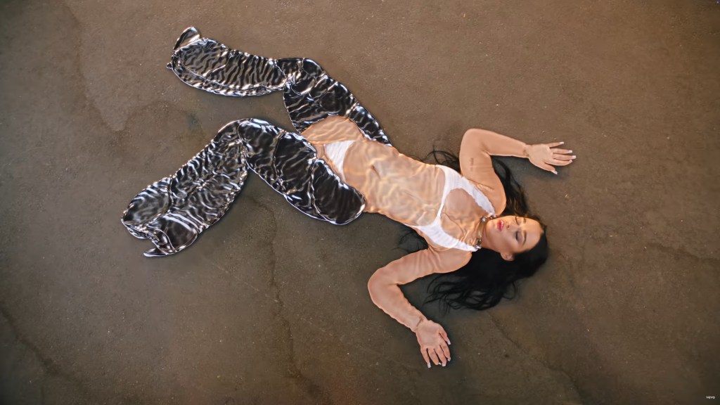 Katy Perry looking as if her body has been flattened on a beach