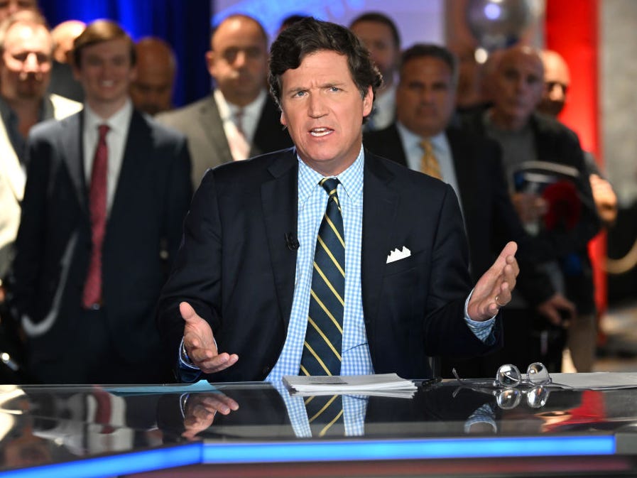 Tucker Carlson speaking at an event