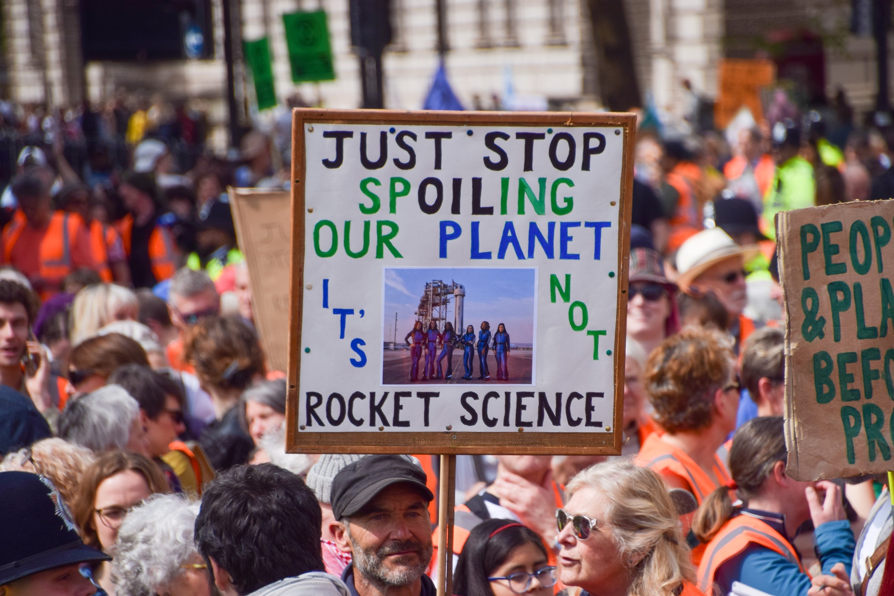 Climate-crisis activists in London used photos of the Blue Origin crew during a protest.