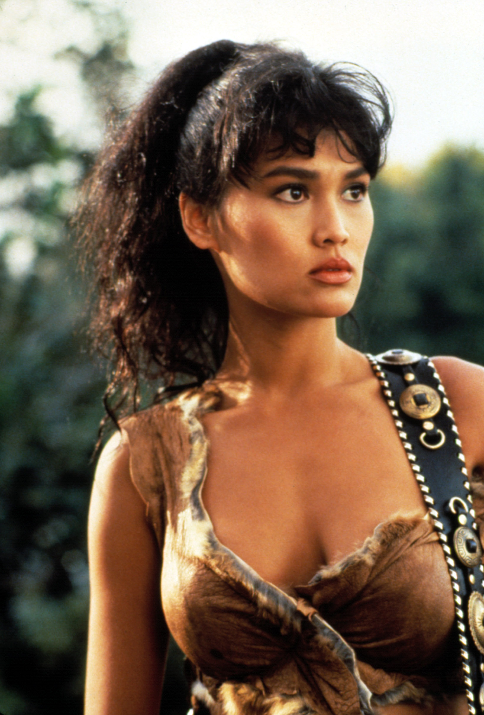 Tia Carrere performs with a guitar in a photo from 