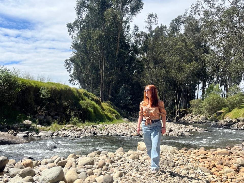 A woman walking near the water in Ecuador.