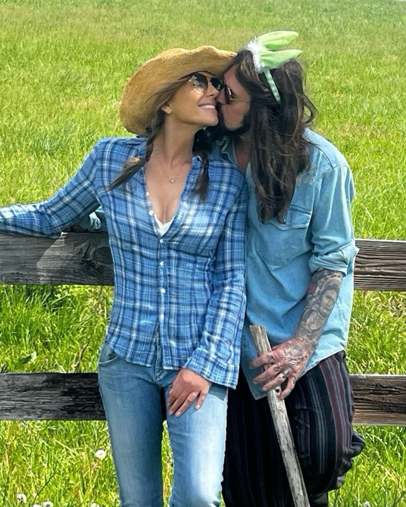 Billy Ray Cyrus kisses Elizabeth Hurley on the cheek while wearing Easter bunny ears in an Instagram post Sunday, April 20.