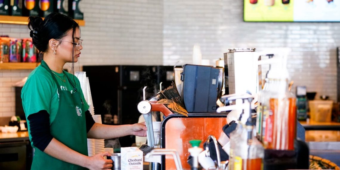Starbucks is staffing up its stores with baristas and ditching machines in the latest stage of its turnaround