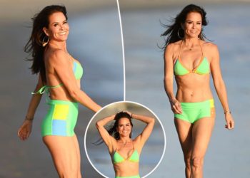 Brooke Burke, 53, flaunts toned abs in neon bikini while frolicking on the beach in Malibu