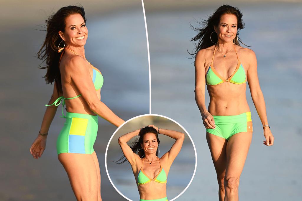 Brooke Burke, 53, flaunts toned abs in neon bikini while frolicking on the beach in Malibu
