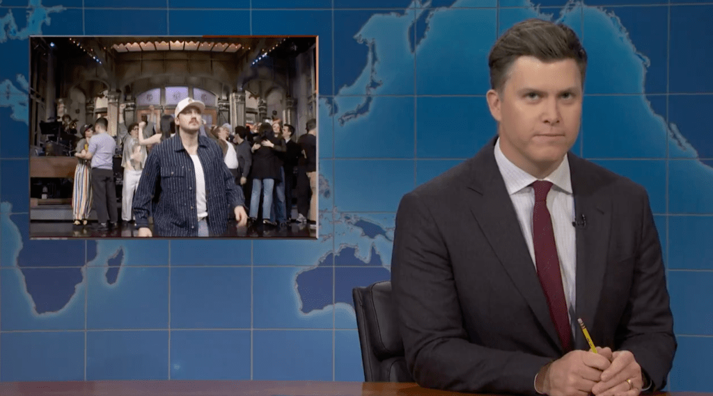 Colin Jost Continues ‘SNL’ Roast Of Morgan Wallen: “Money Is Leaving The Stock Market Faster Than” Country Singer During Goodnights