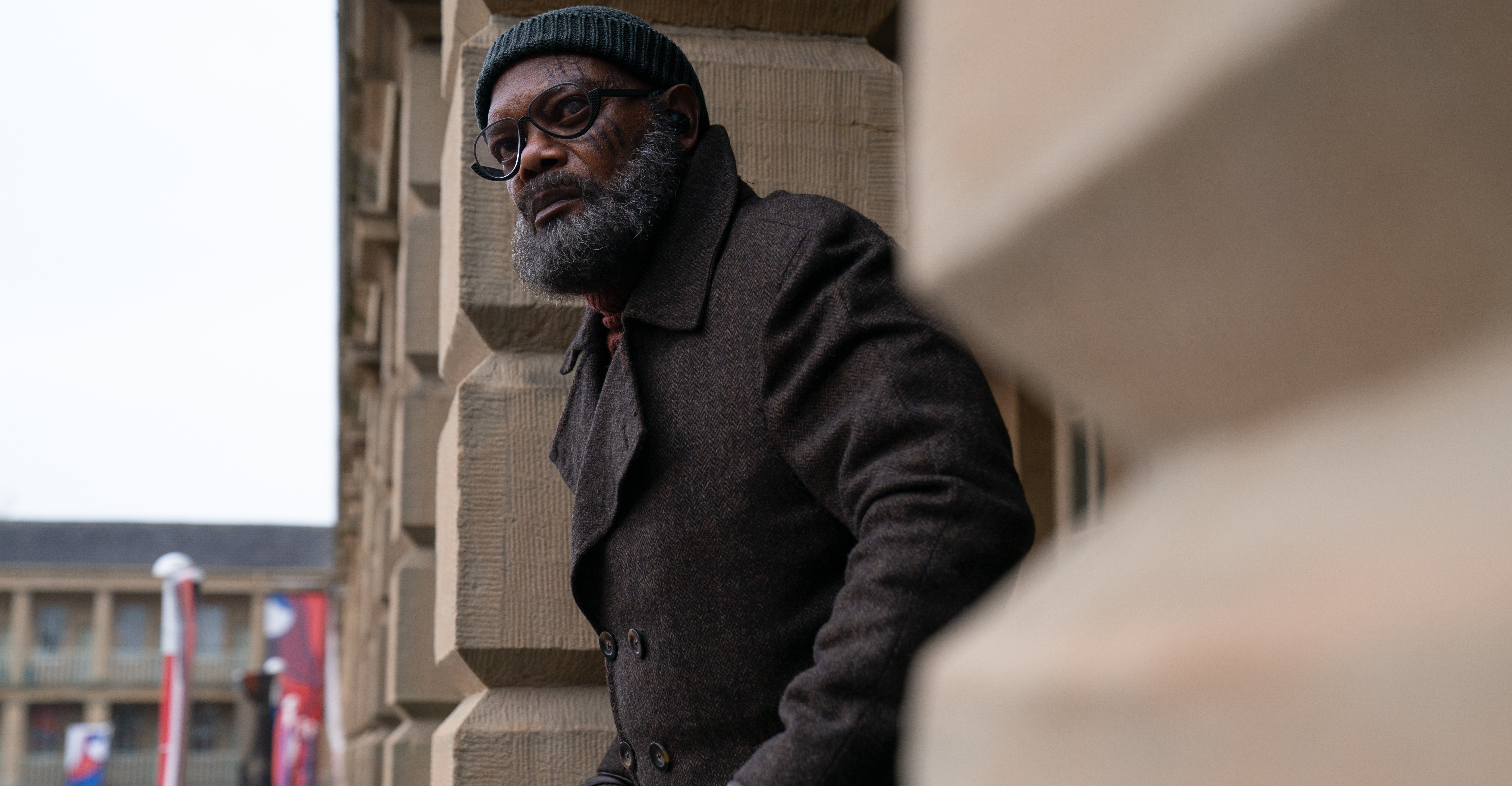 Nick Fury (Samuel L. Jackson) leans over a railing looking at something