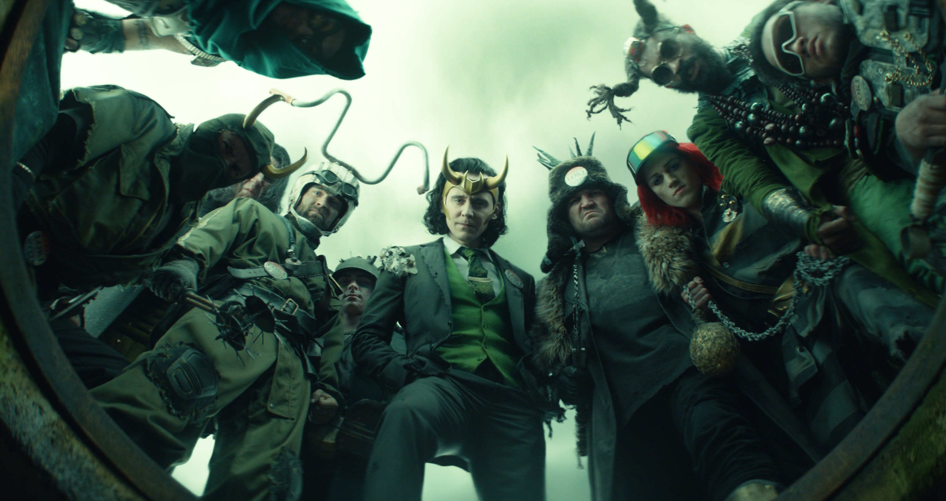 A whole buncha Lokis, centered on President Loki, look down at the camera in episode 5 of Loki