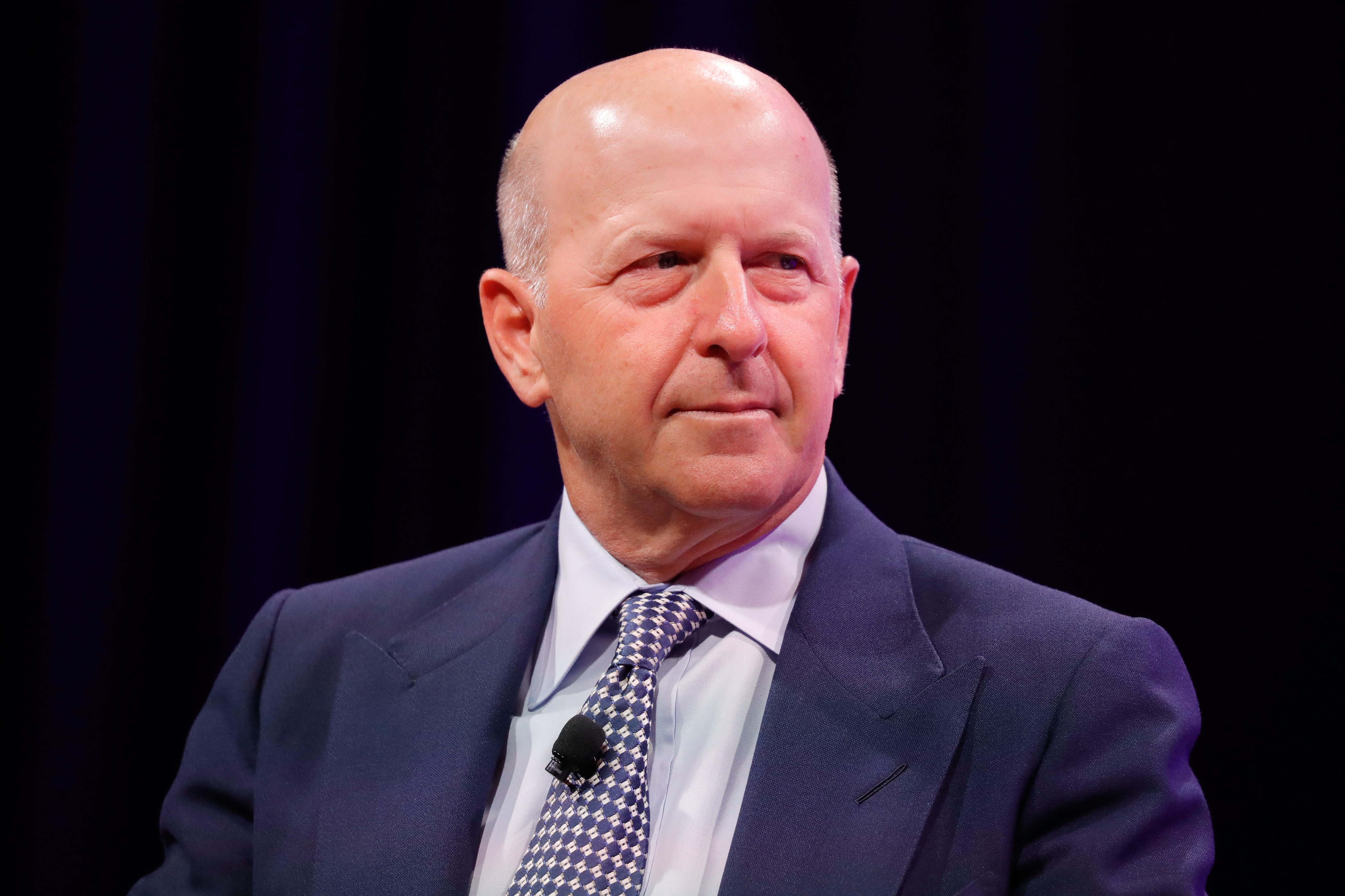 A man in a suit looks to the left