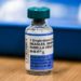 What causes breakthrough measles infections even if someone is vaccinated?