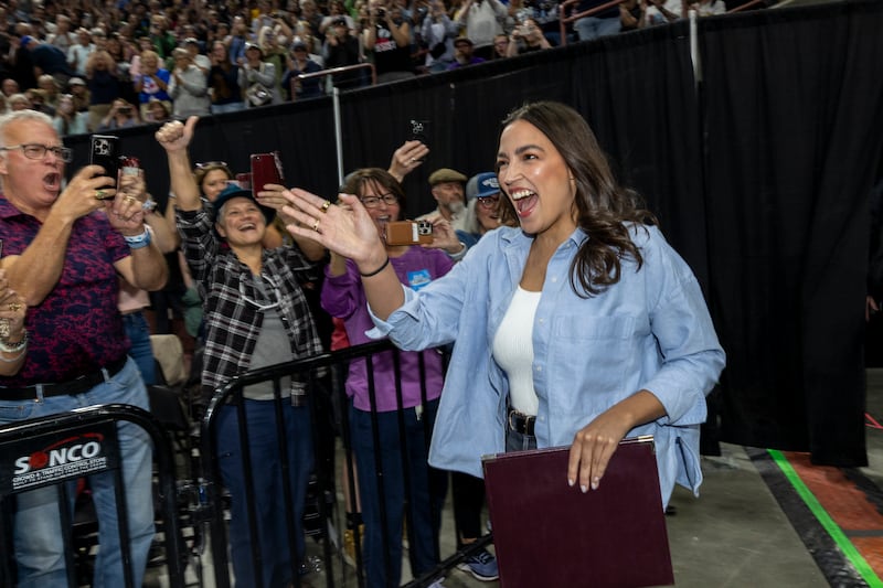 NAMPA, IDAHO - APRIL 14: U.S. Rep. Alexandria Ocasio-Cortez (D-NY) waves as she enters to a full auditorium as part of the "Fighting Oligarchy" tour on April 14, 2025 in Nampa, Idaho. According to event organizers, 12,500 people attended the rally. (Photo by Natalie Behring/Getty Images)