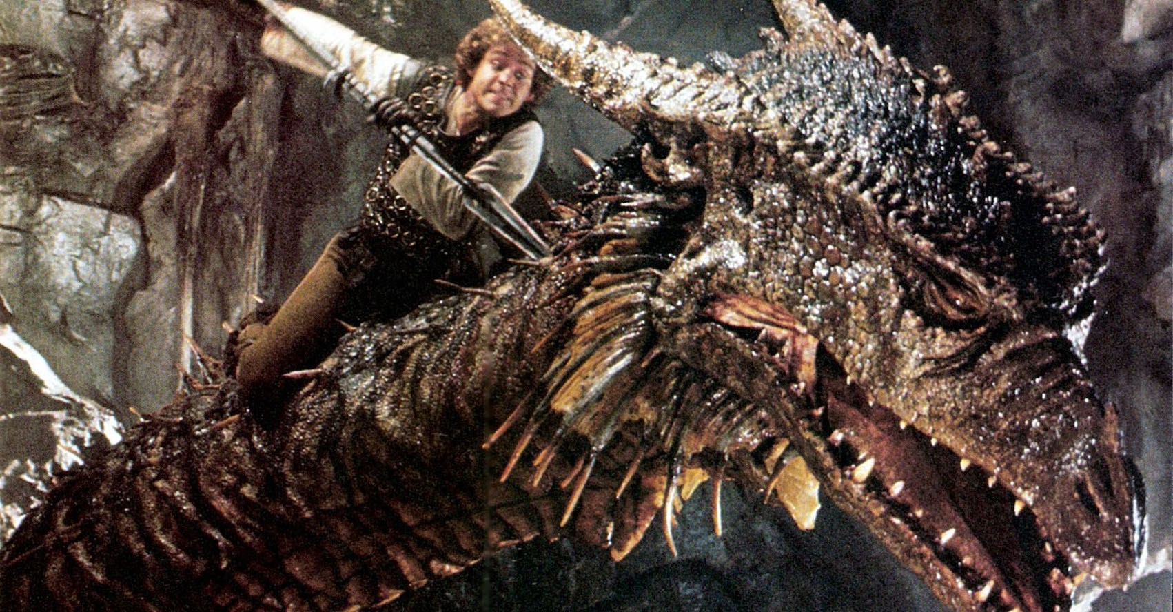 a man stabbing a dragon in the neck with a spear