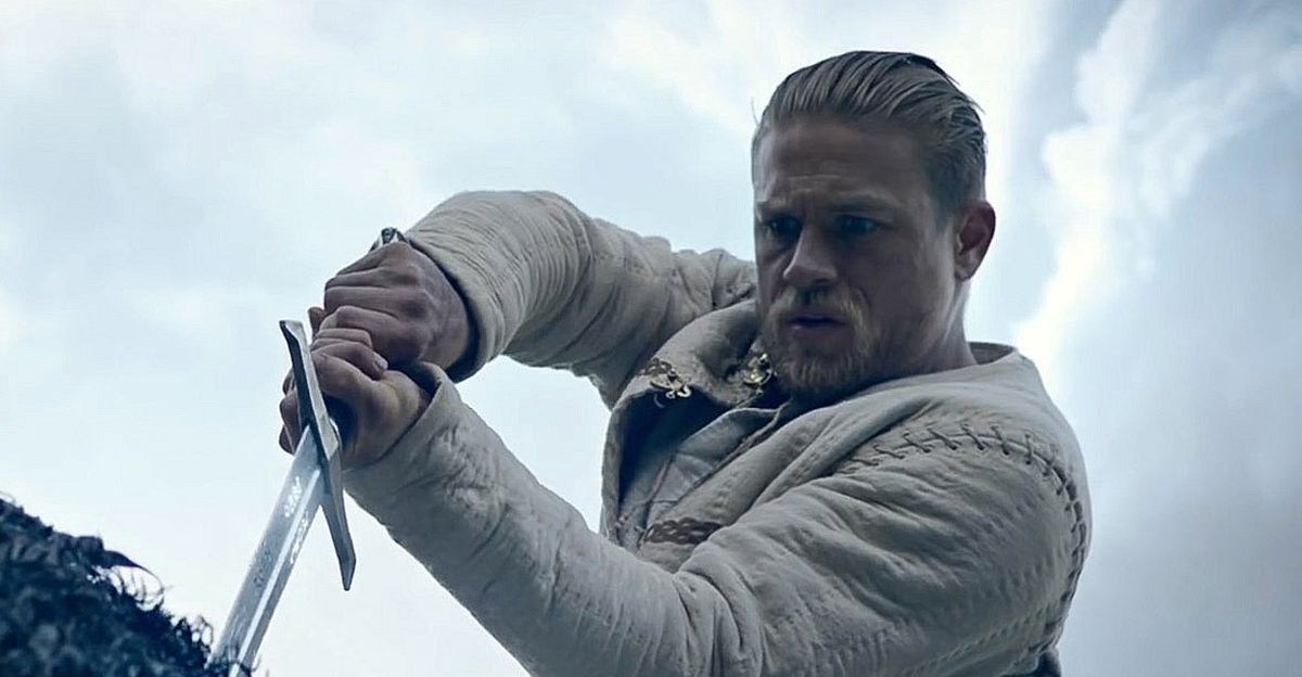 Charlie Hunnam as Arthur pulling Excalibur from the stone in King Arthur: Legend of the Sword.