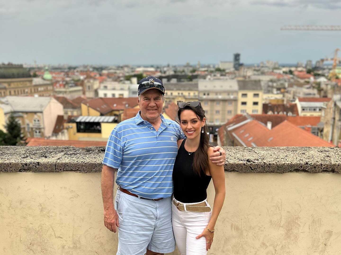 Jordon Hudson and Bill Belichick pose for a photo. 