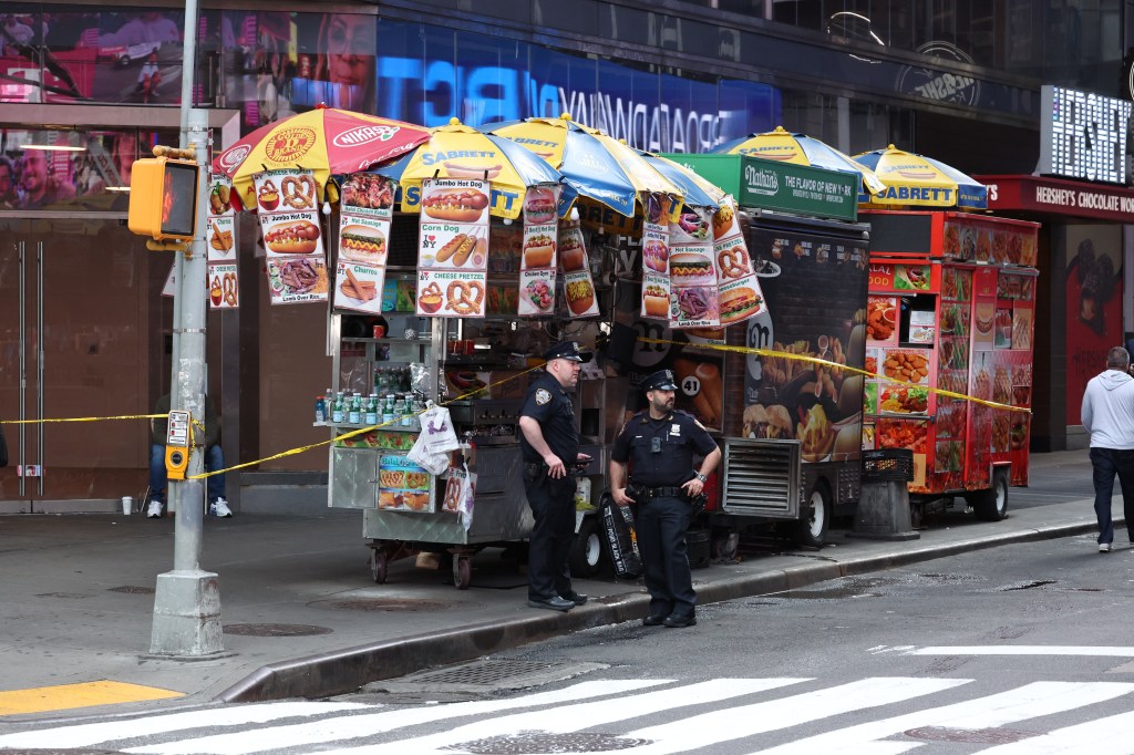 NYPD officers secure the scene at West 47th Street and Seventh Avenue near Times Square after a 29-year-old food vendor was shot in the arm around 5:00 a.m. Wednesday 