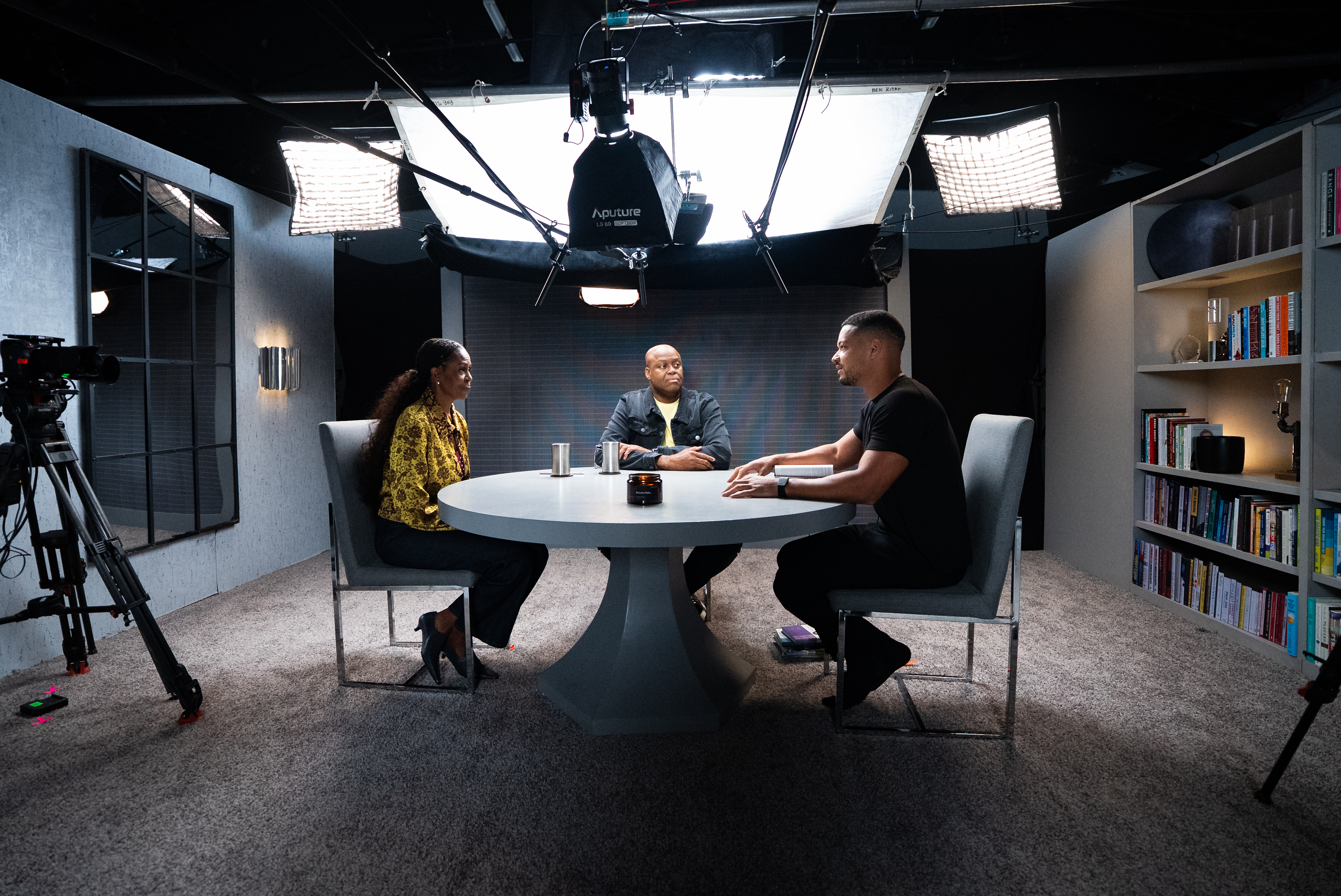 Michelle Obama sits at a table with Steven Bartlett. 