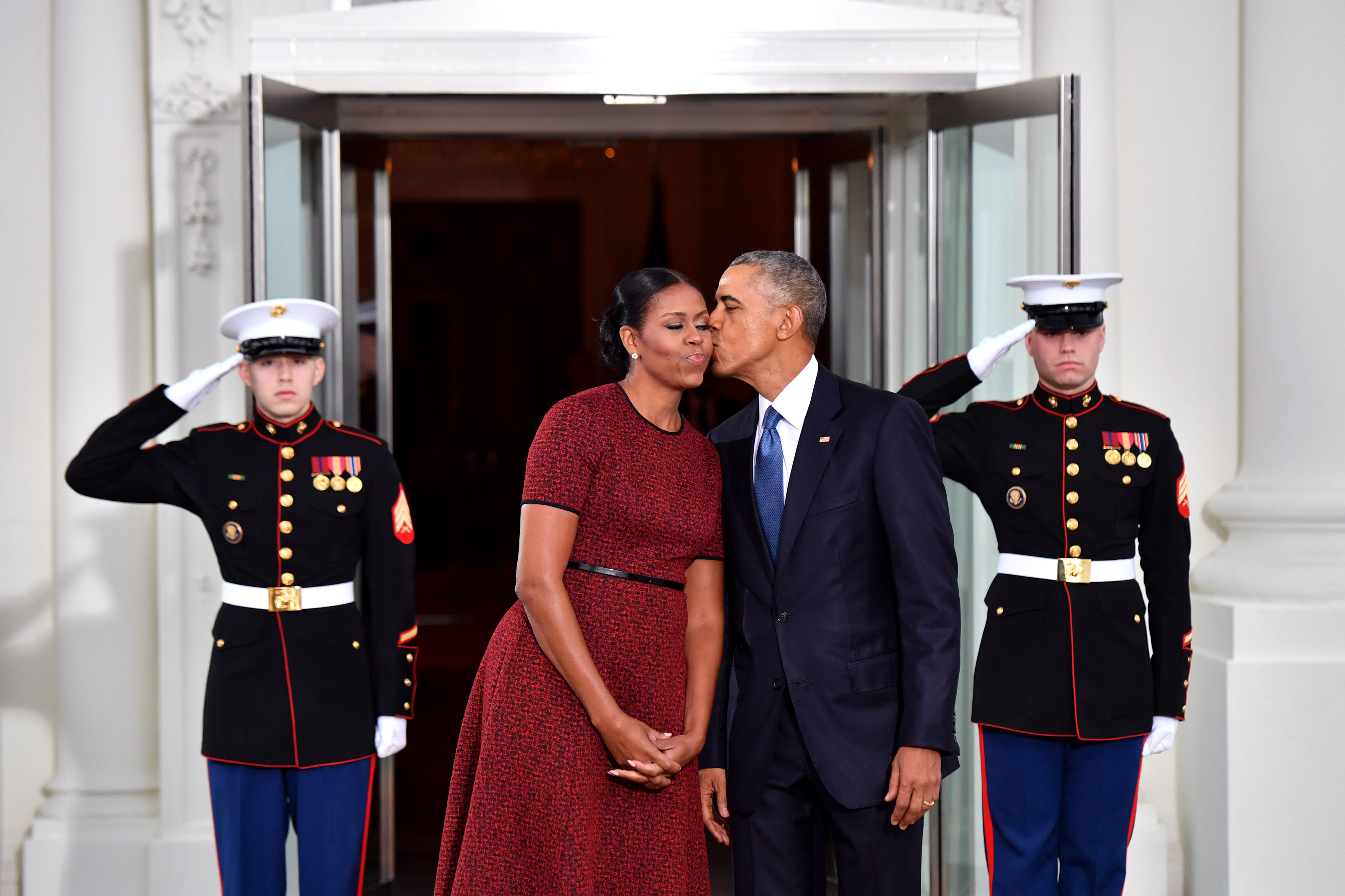 Barack and Michelle Obama stand on stairs on inauguration day 2017. 