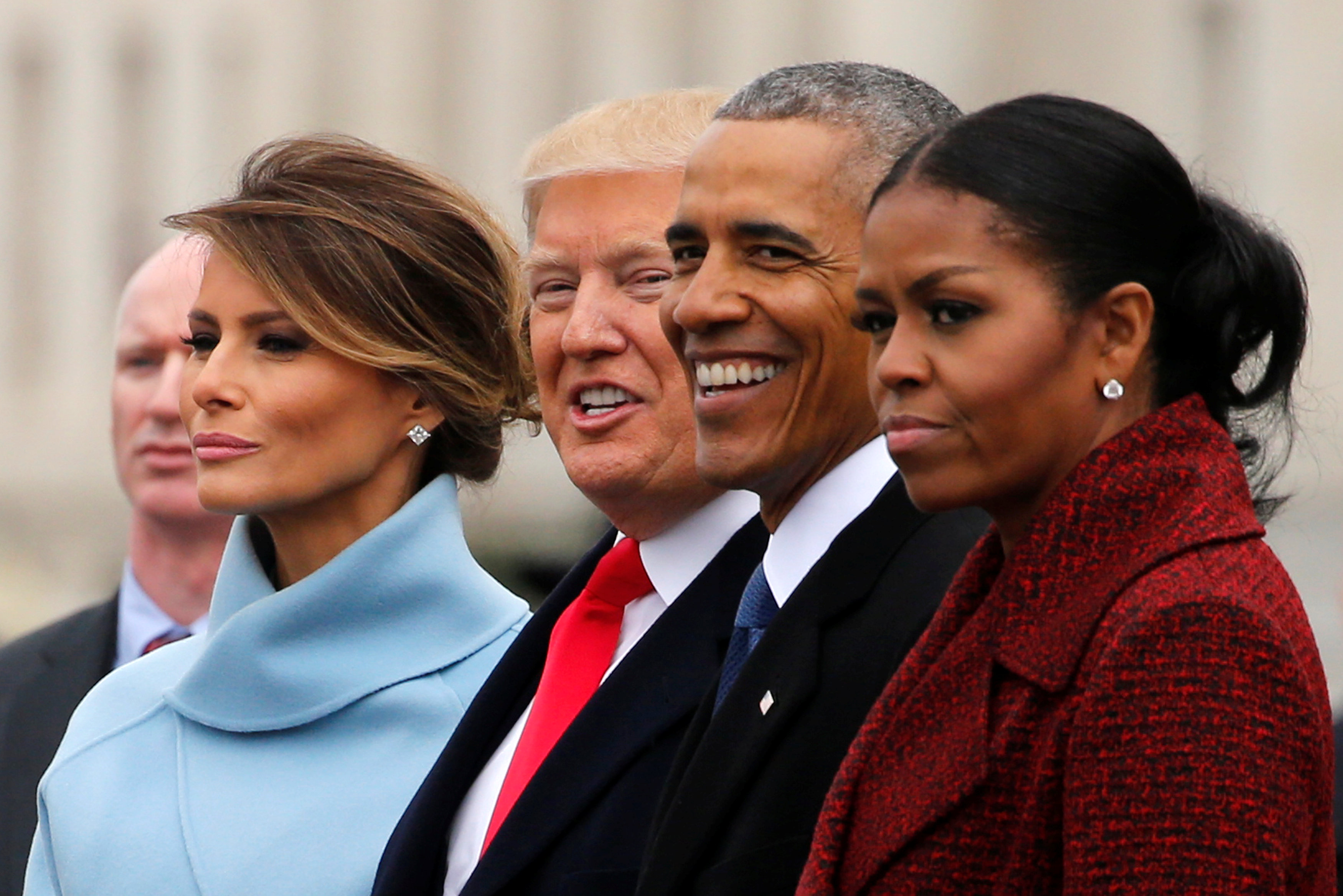 Michelle and Barack Obama sit outdoors alongside Donald and Melania Trump. 