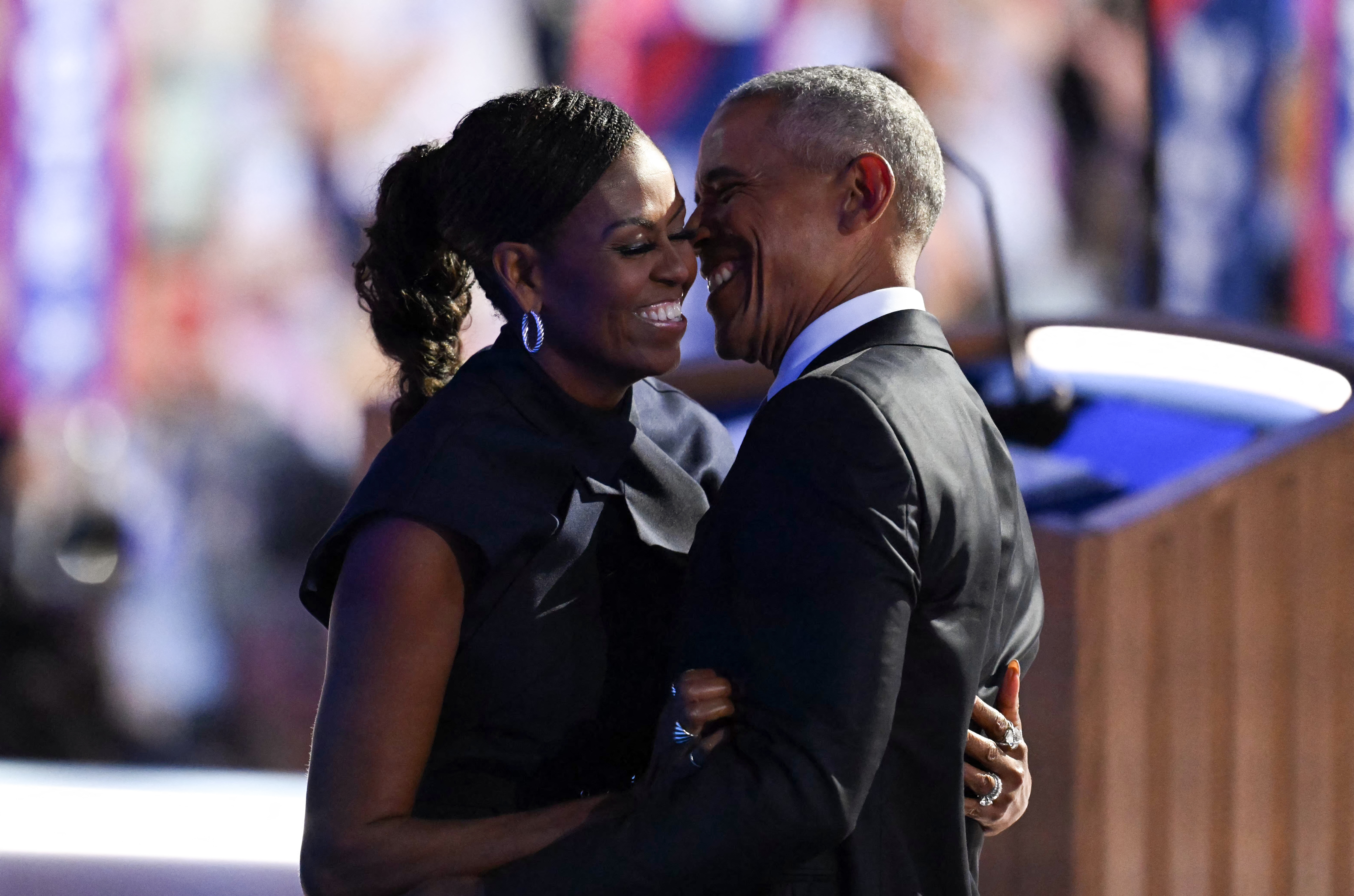 Barack and Michelle Obama dance at an event. 