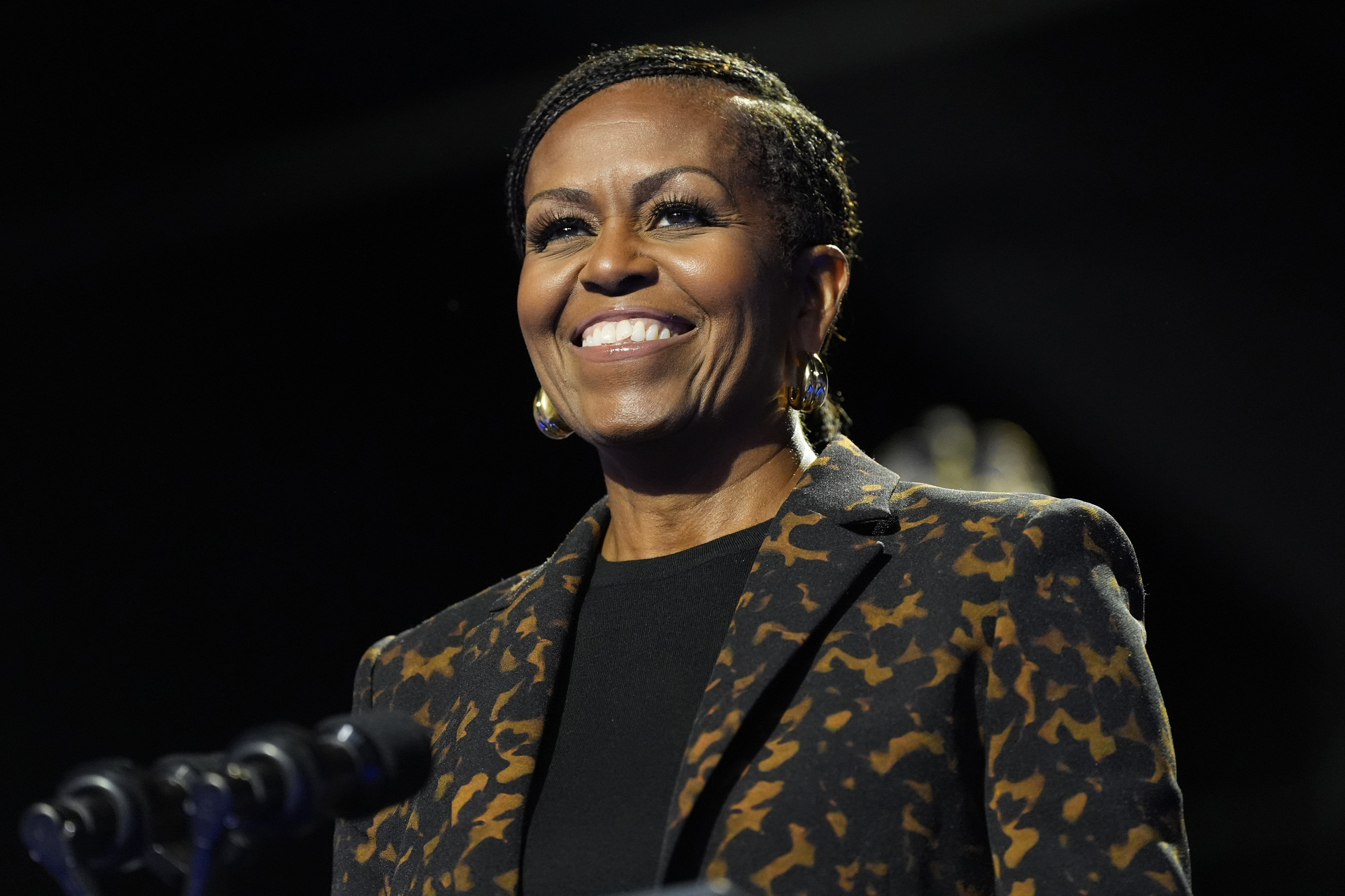 Michelle Obama smiles at an event. 