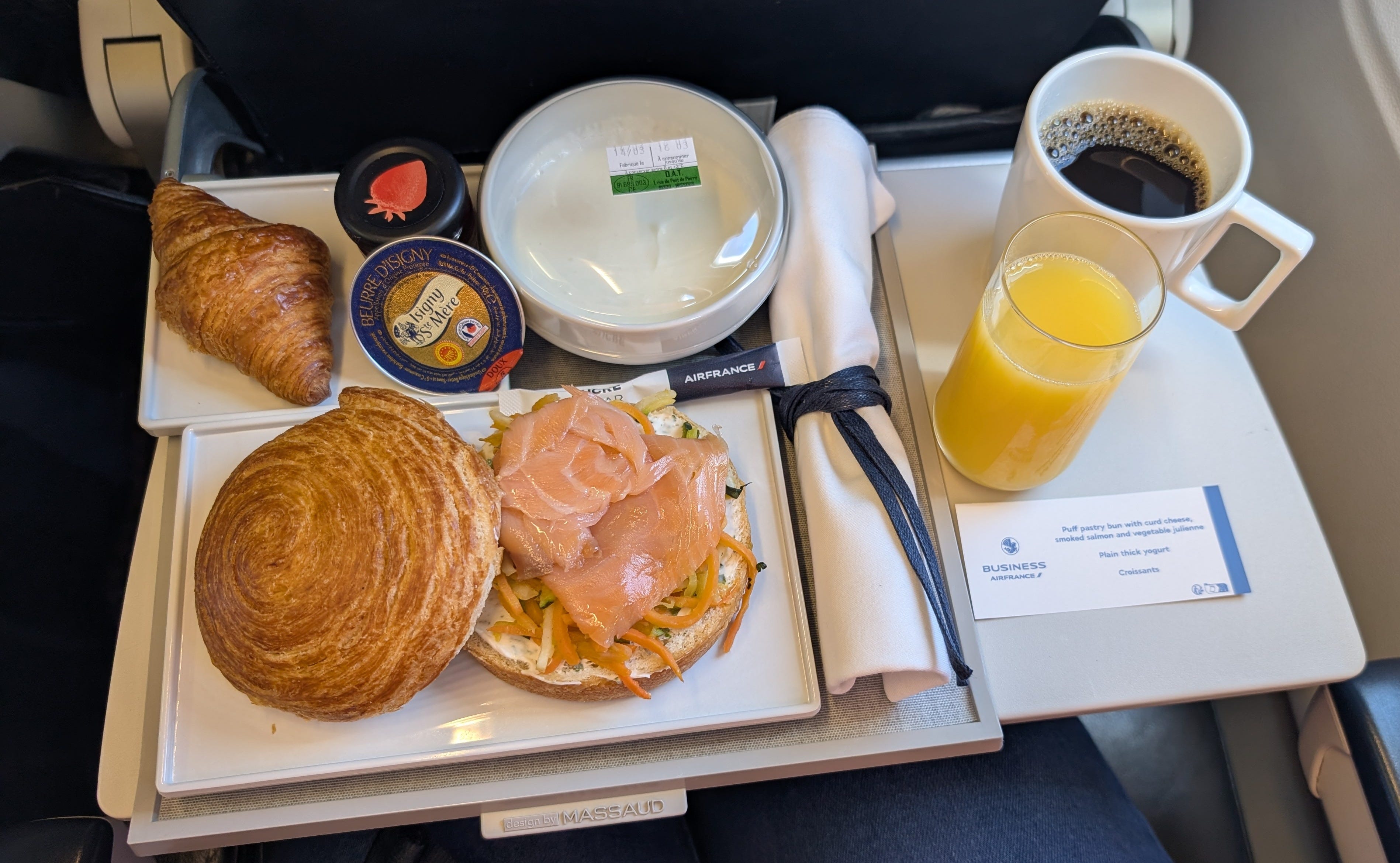Croissant, orange juice, coffee, and bowl on tray table