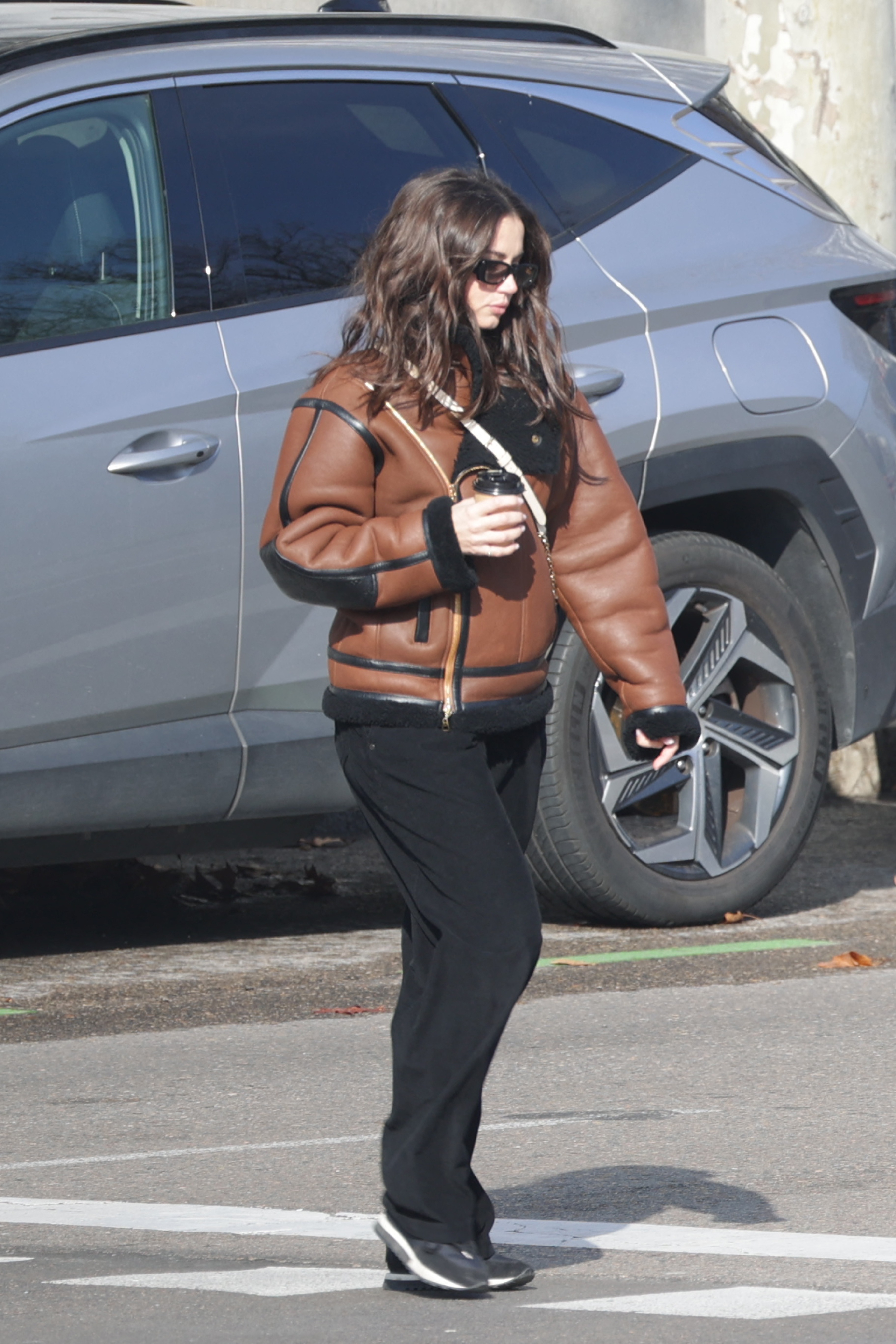 Ana de Armas pictured in a brown leather jacket.