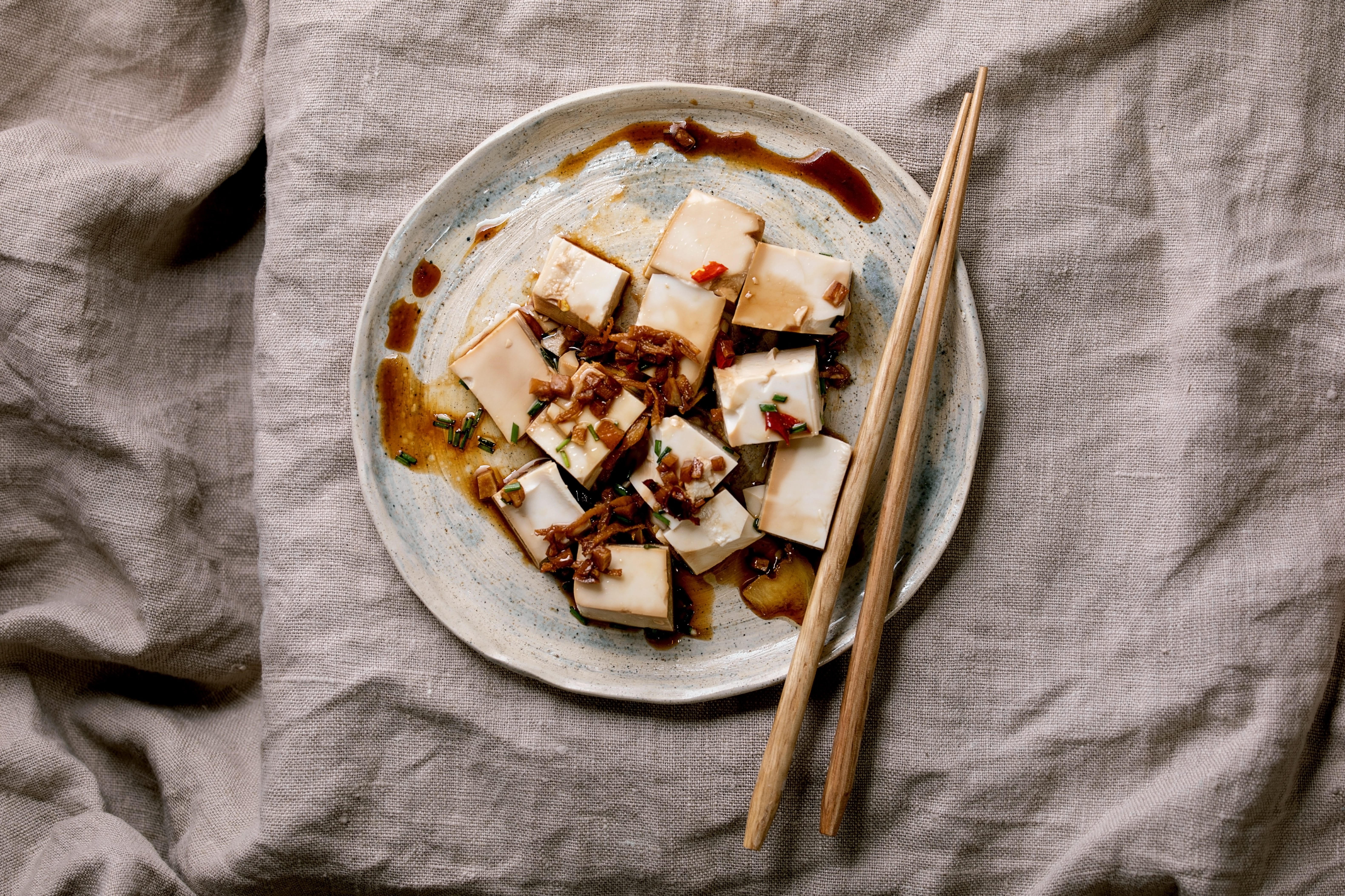 Tofu on a plate with chopsticks