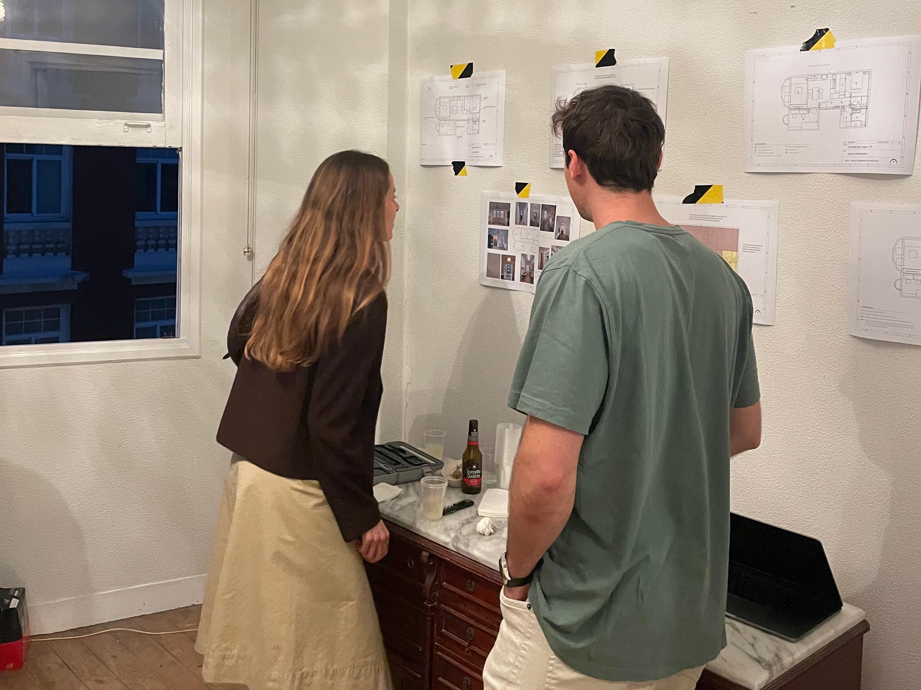 Two young people looking a plans for an apartment under renovation.