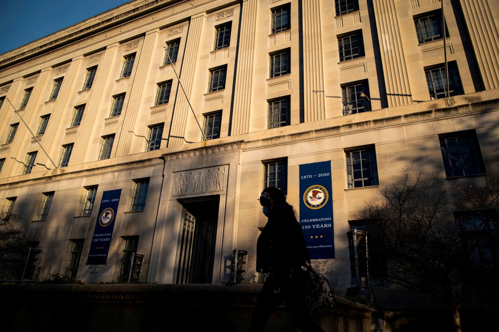A woman walking past the U.S. Department of Justice Building in Washington, U.S., on December 15, 2020.