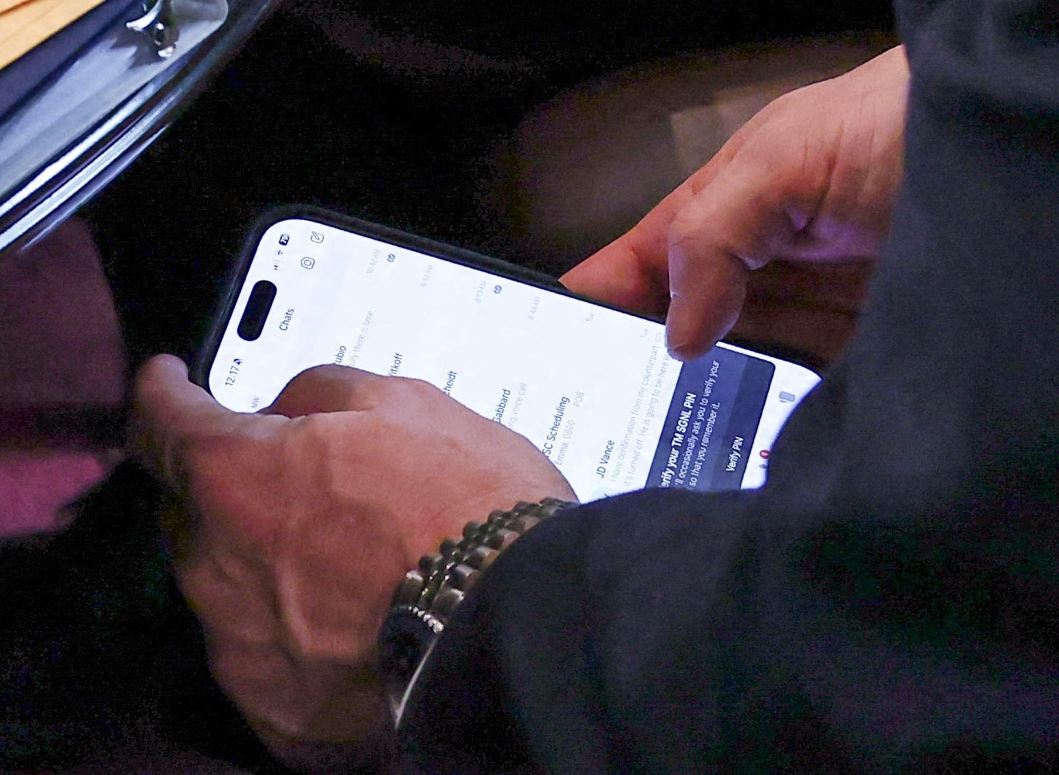 US national security advisor Mike Waltz checks his mobile phone while attending a cabinet meeting.