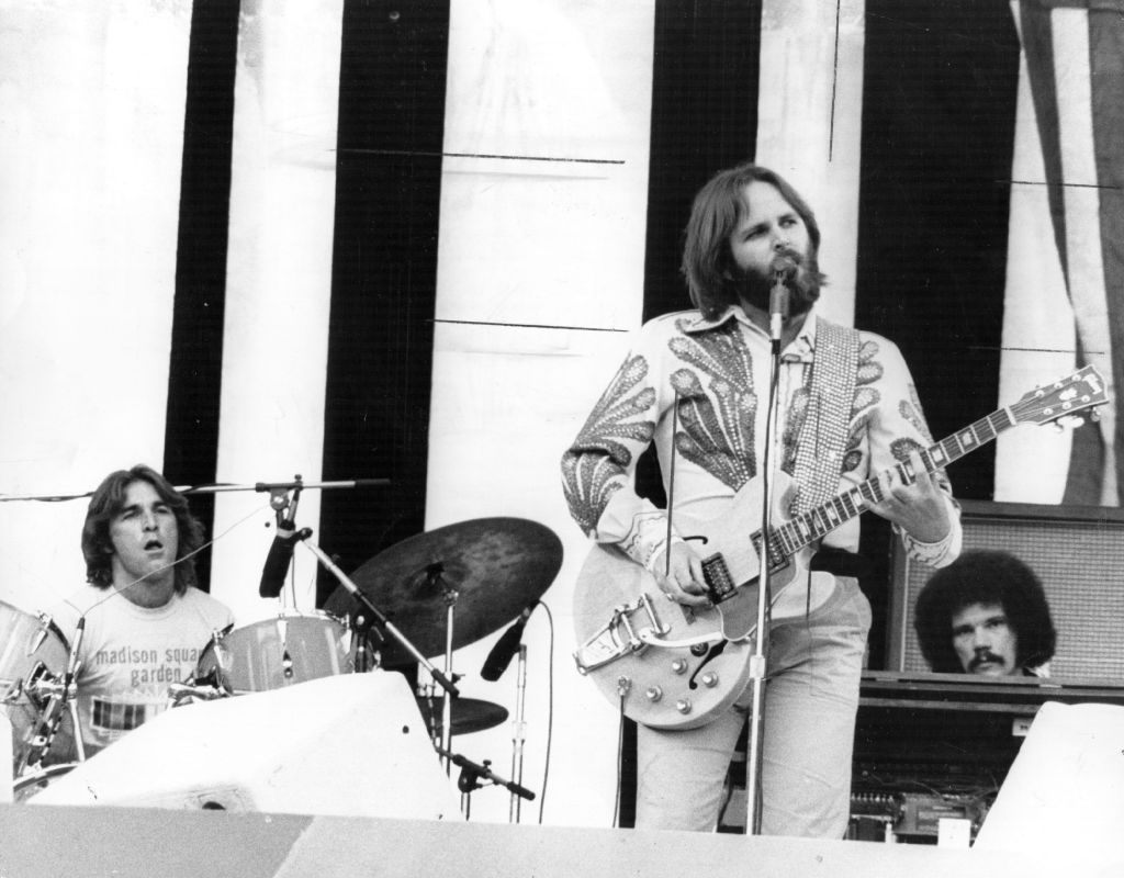 Carl Wilson (1946 - 1998), guitar and vocals, and Dennis Wilson (1944 - 1983), drums, of the American surf group The Beach Boys, performing live.  