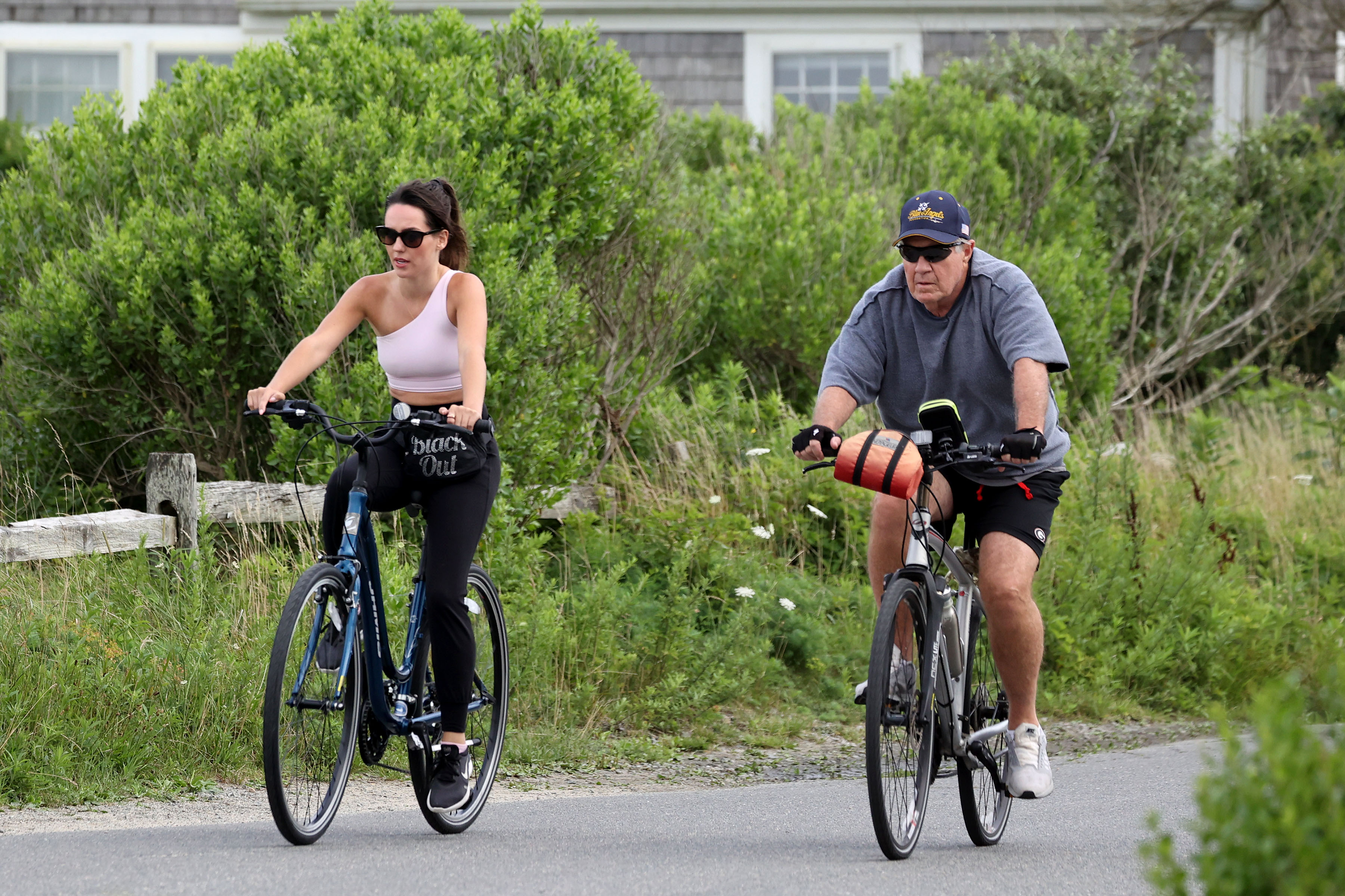 Jordon Hudson and Bill Belichick riding bikes. 