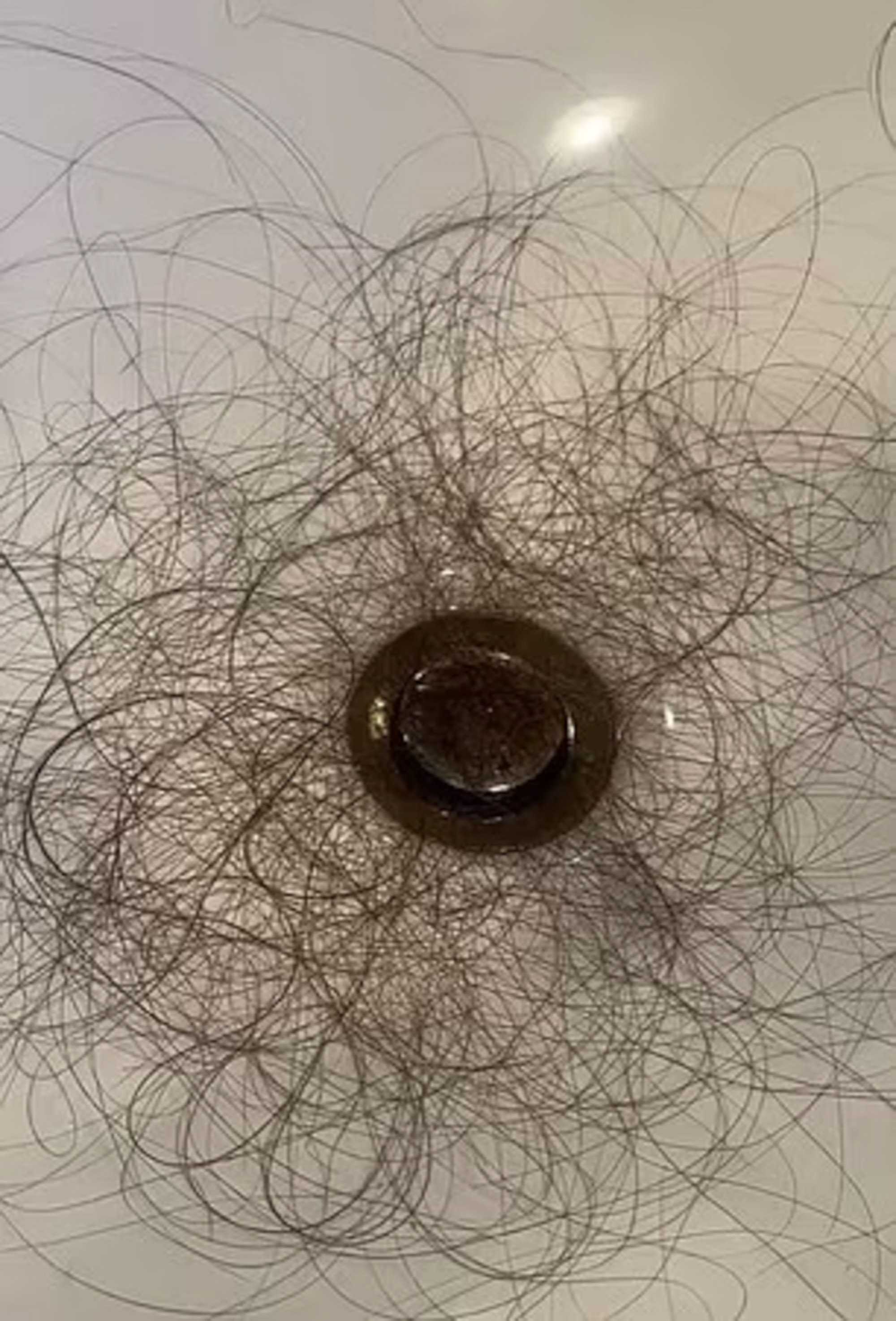 Hair in and around drain. 